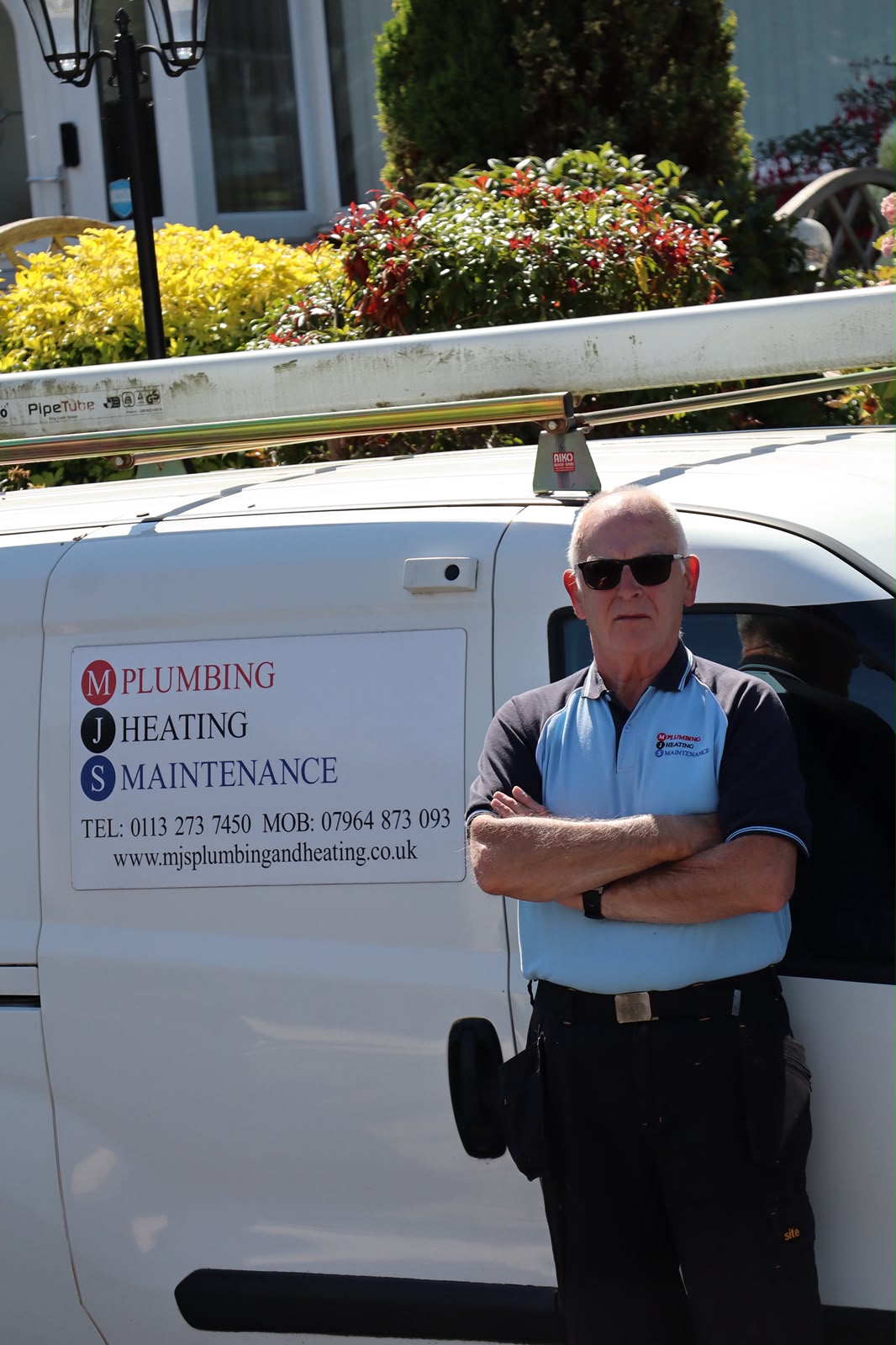 MJS Plumbing and Heating Maintenance plumber beside branded van in Shadwell, Leeds